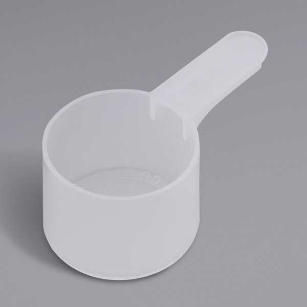 A white plastic measuring scoop with a short handle.