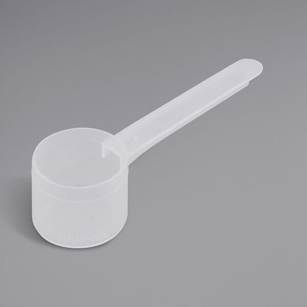 A white plastic measuring scoop with a long handle.