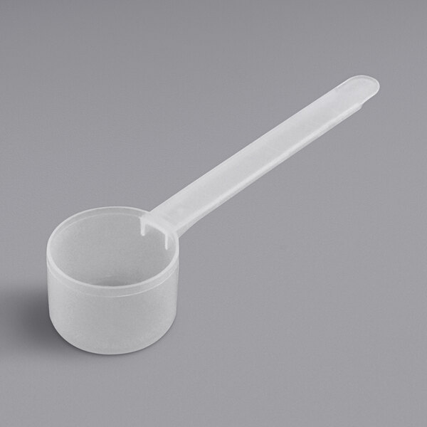 A plastic measuring spoon with a long handle.