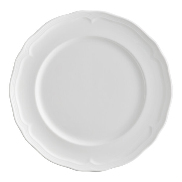 A white porcelain plate with a scalloped wide rim.