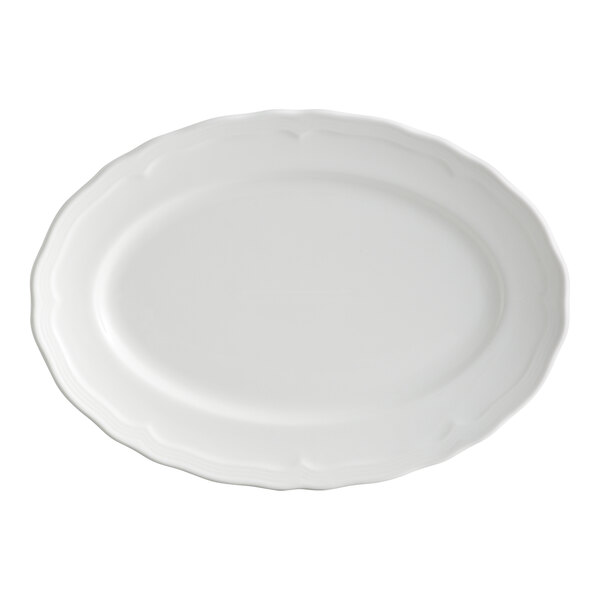 An oval-shaped, pearl white porcelain platter with a scalloped wide rim.