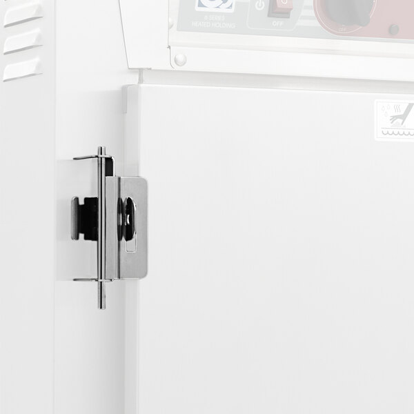 A white refrigerator door secured with a silver Metro Travel Latch.