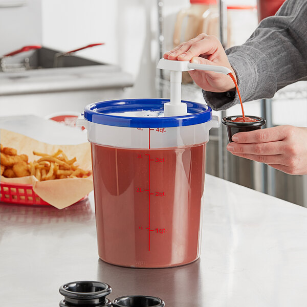 A person using a Choice condiment pump to pour red liquid into a container.