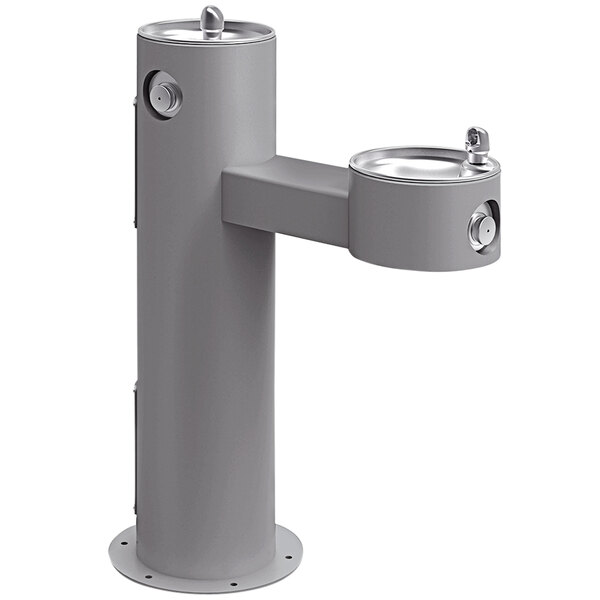 An Elkay gray outdoor bi-level pedestal drinking fountain with two spouts.