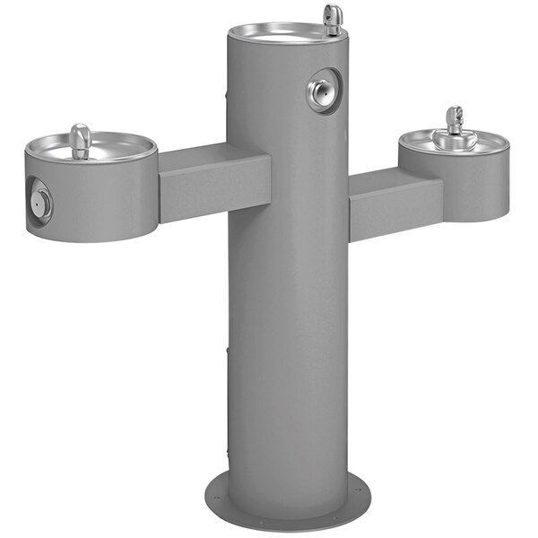 An Elkay gray metal outdoor tri-level pedestal drinking fountain with three spouts.