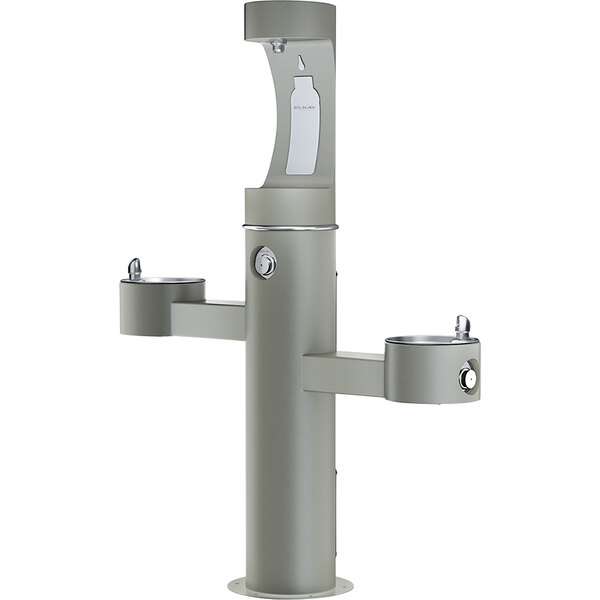 An Elkay gray outdoor pedestal drinking fountain with two water fountains.