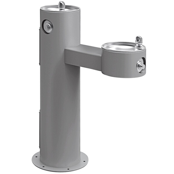 An Elkay gray outdoor bi-level pedestal drinking fountain with two spouts.