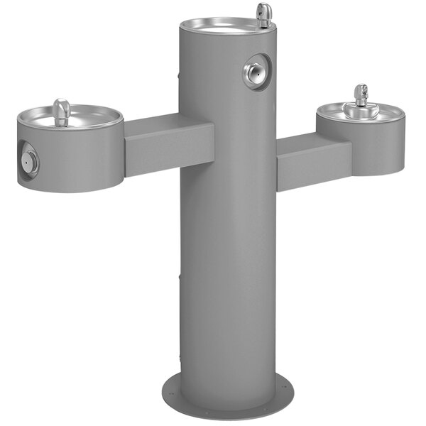 A gray metal Elkay outdoor tri-level pedestal drinking fountain with three spouts.