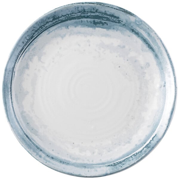 A white Dudson Maker's Finca china plate with blue and white speckles.