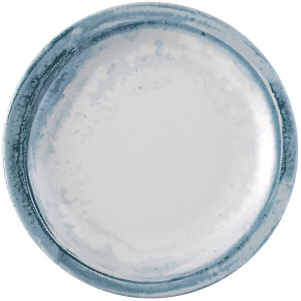 A close up of a Dudson Maker's Finca limestone China plate with blue specks.