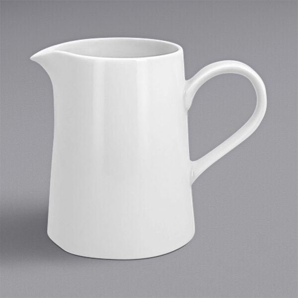 A white pitcher with a handle.