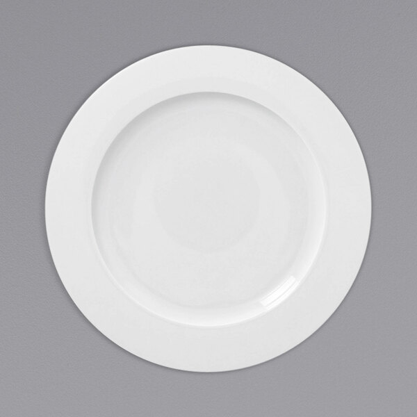 A white RAK Porcelain flat plate with a white rim.