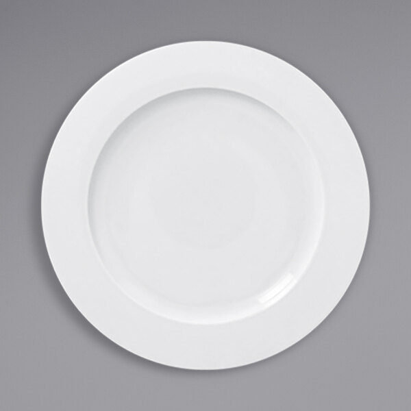 A white RAK Porcelain flat plate with a white rim.