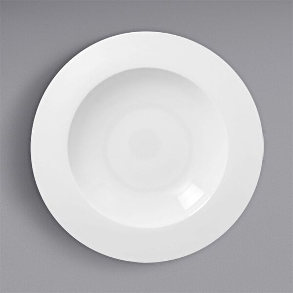 A white porcelain deep plate with a wide rim.