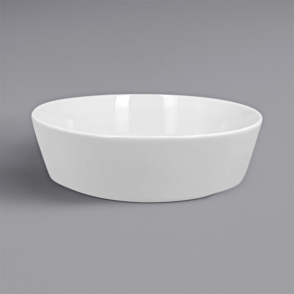 A RAK Porcelain white bowl on a gray surface.