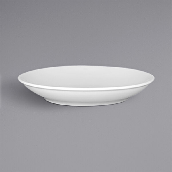 A white porcelain deep coupe plate with a gray background.