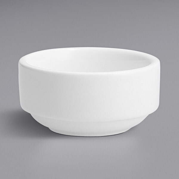 A Fortessa white porcelain ramekin on a gray surface.