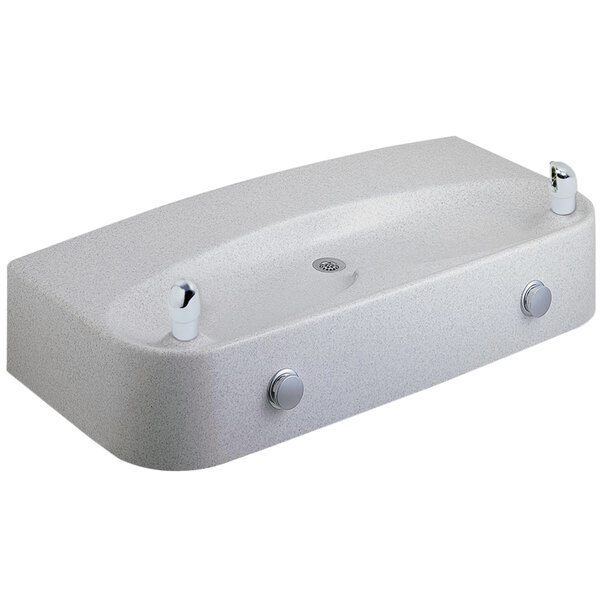 A white granite composite Halsey Taylor drinking fountain with three faucets.