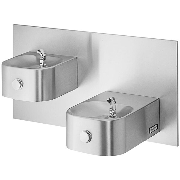 A Halsey Taylor stainless steel bi-level wall mount drinking fountain with two taps.