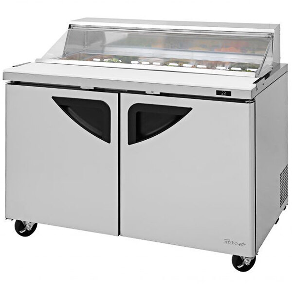 A Turbo Air Super Deluxe refrigerated sandwich prep table with clear lid and two doors.