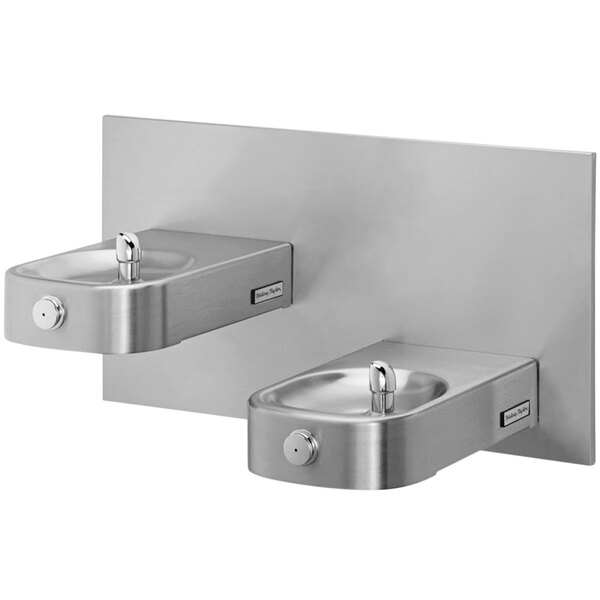 A Halsey Taylor stainless steel heavy-duty bi-level wall mount drinking fountain with frame.
