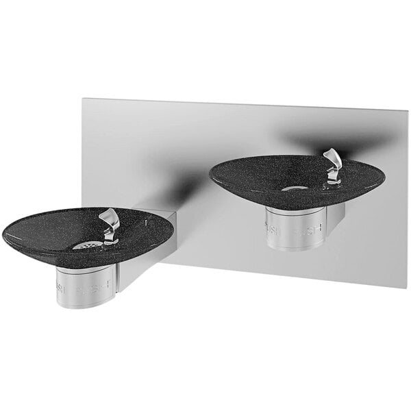 A Halsey Taylor oval black marble wall mount drinking fountain with two black basins.