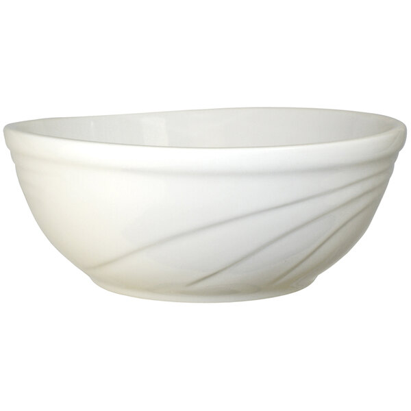 An International Tableware York ivory stoneware bowl with a curved design.