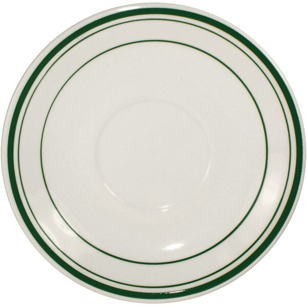 An ivory stoneware saucer with green bands.