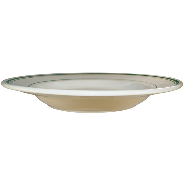 An International Tableware ivory stoneware pasta bowl with green bands on the rim.