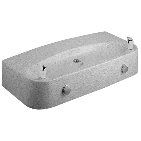 A white rectangular Marblyte drinking fountain with two faucets.