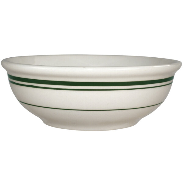 An ivory stoneware bowl with green stripes.