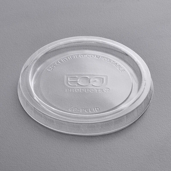 A clear Eco-Products compostable plastic lid for portion cups with a logo on it.