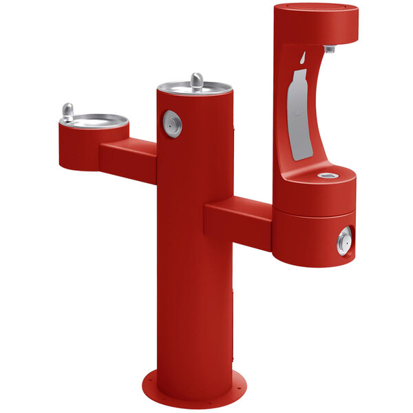 A red Halsey Taylor drinking fountain with two water fountains and silver handles.