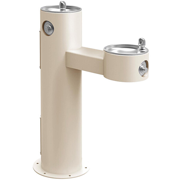 A beige outdoor tubular bi-level drinking fountain with silver handles.
