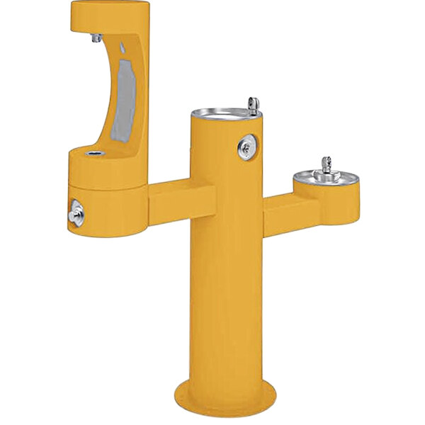 A yellow Halsey Taylor water fountain with two silver faucets.