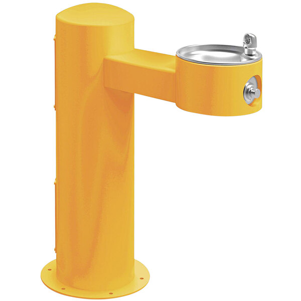 A yellow drinking fountain with a silver metal rim.