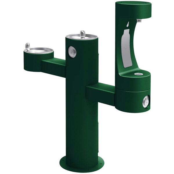 A green drinking fountain with two silver drinking fountains.
