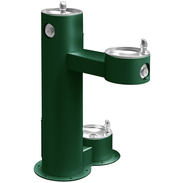 A green drinking fountain with two taps.