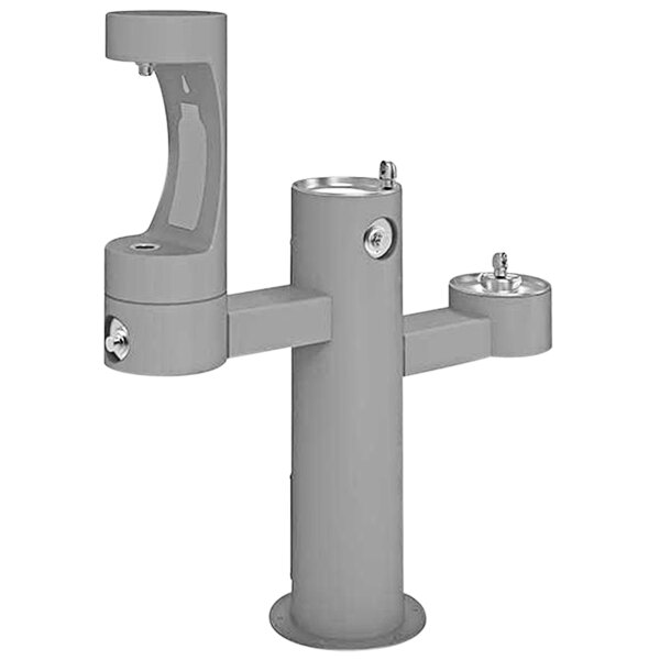 A gray drinking fountain with two taps.