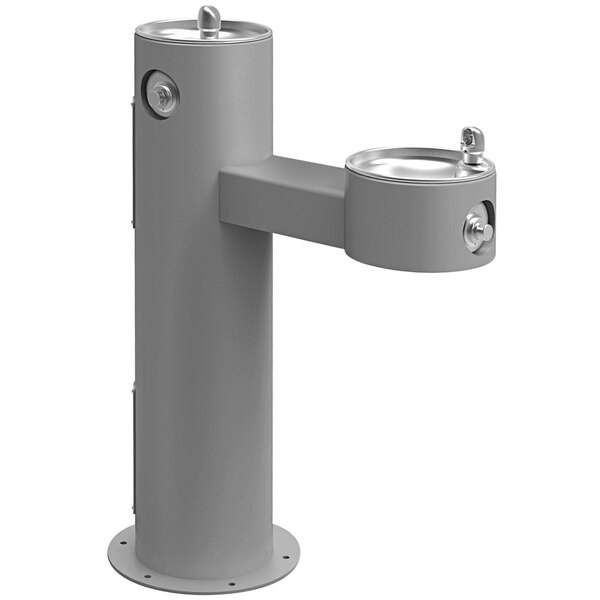A gray Halsey Taylor pedestal drinking fountain with two spouts.