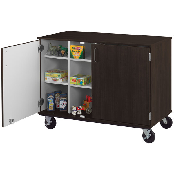 A I.D. Systems mobile storage cart with locking doors, shelves, and a midnight maple finish.