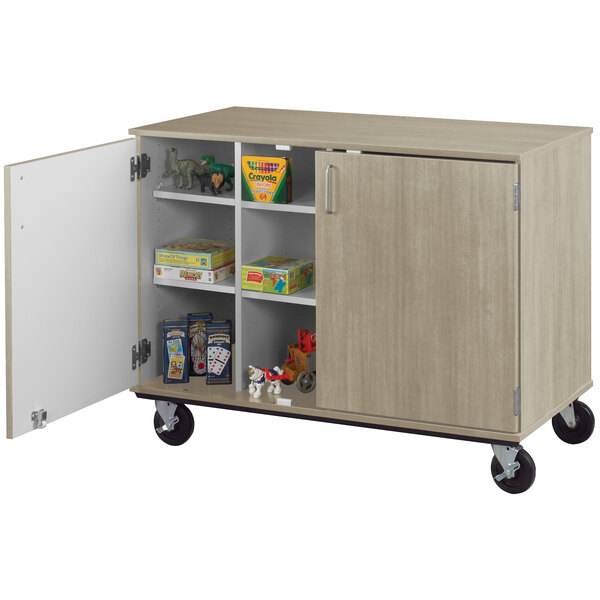 An I.D. Systems mobile cubbie storage cart with locking doors on wheels.