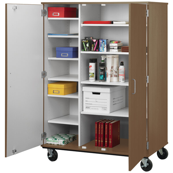 A brown I.D. Systems storage cart with shelves holding books and files.