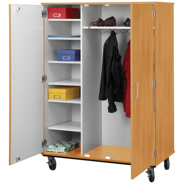 A wooden I.D. Systems shelf and coat storage cart with locking doors.