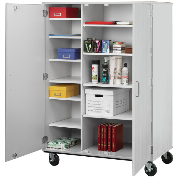 A grey I.D. Systems closed shelf storage cart with shelves holding objects.
