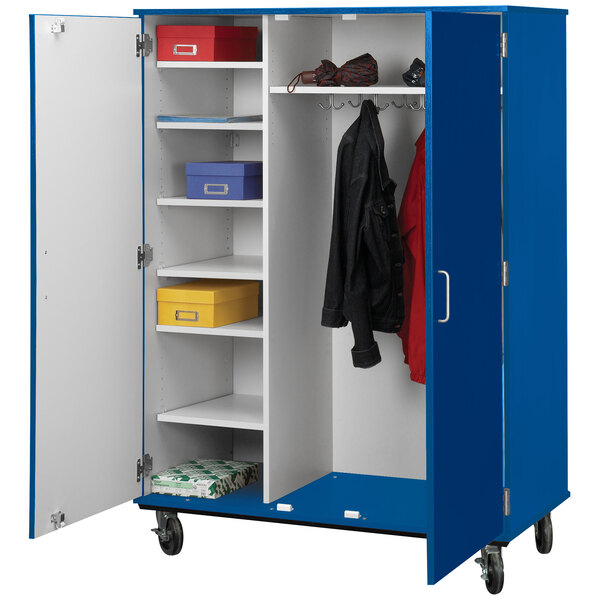 A royal blue locker with shelves and a coat inside.