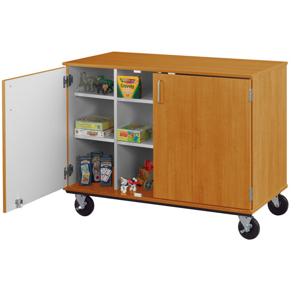 A light oak wooden mobile storage cart with locking doors and shelves.