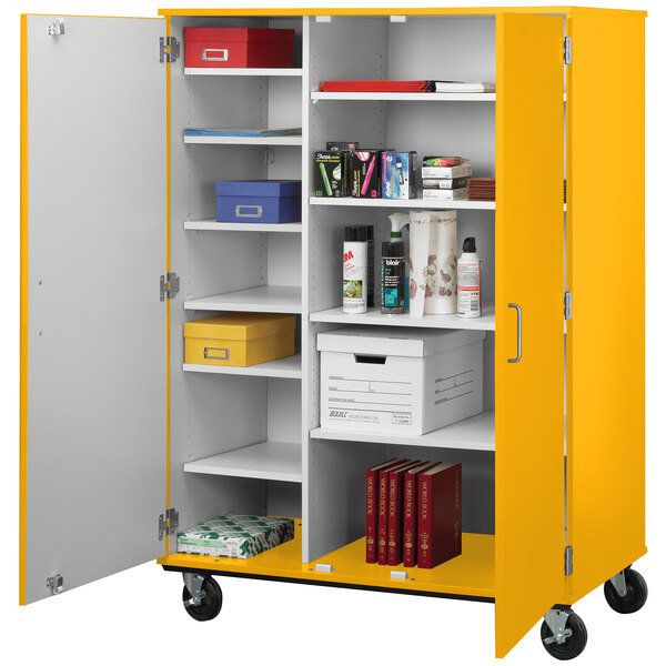 A yellow I.D. Systems storage cart with shelves and objects on wheels.