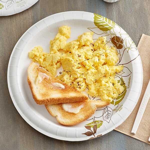 A white Dixie paper plate with buttered toast and scrambled eggs on it.