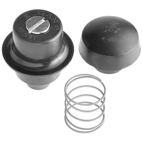 A close-up of a round black plastic object with writing on it - a Sloan control stop repair kit.